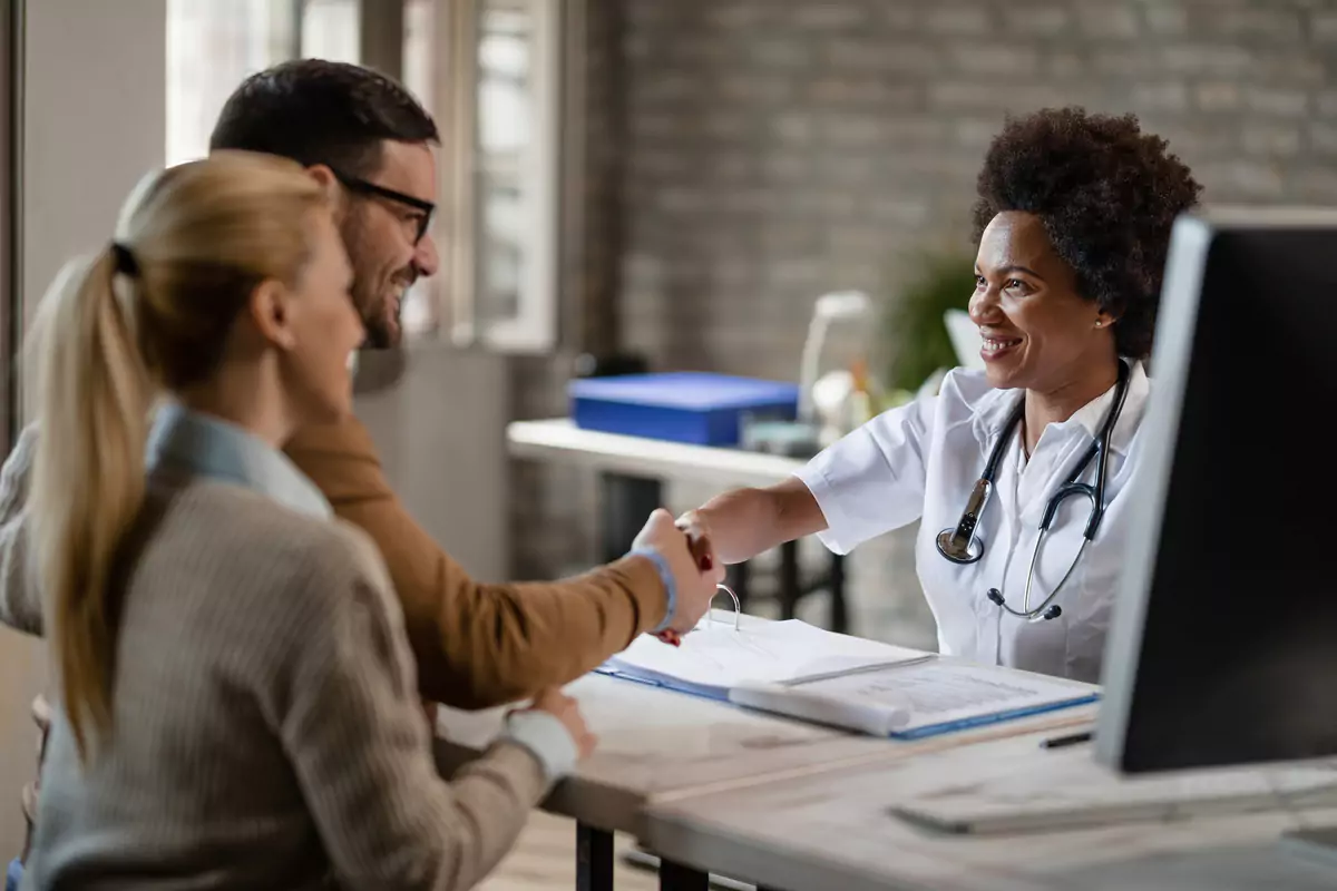 Couple Shaking Hands Black Female Doctor